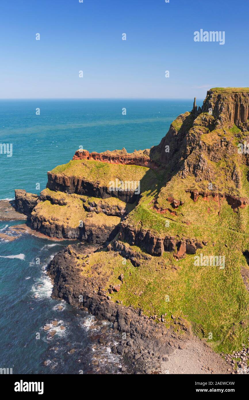 Cliffs with the Chimney Stacks rock formation on the Causeway Coast in Northern Ireland on a bright and sunny day. Stock Photo