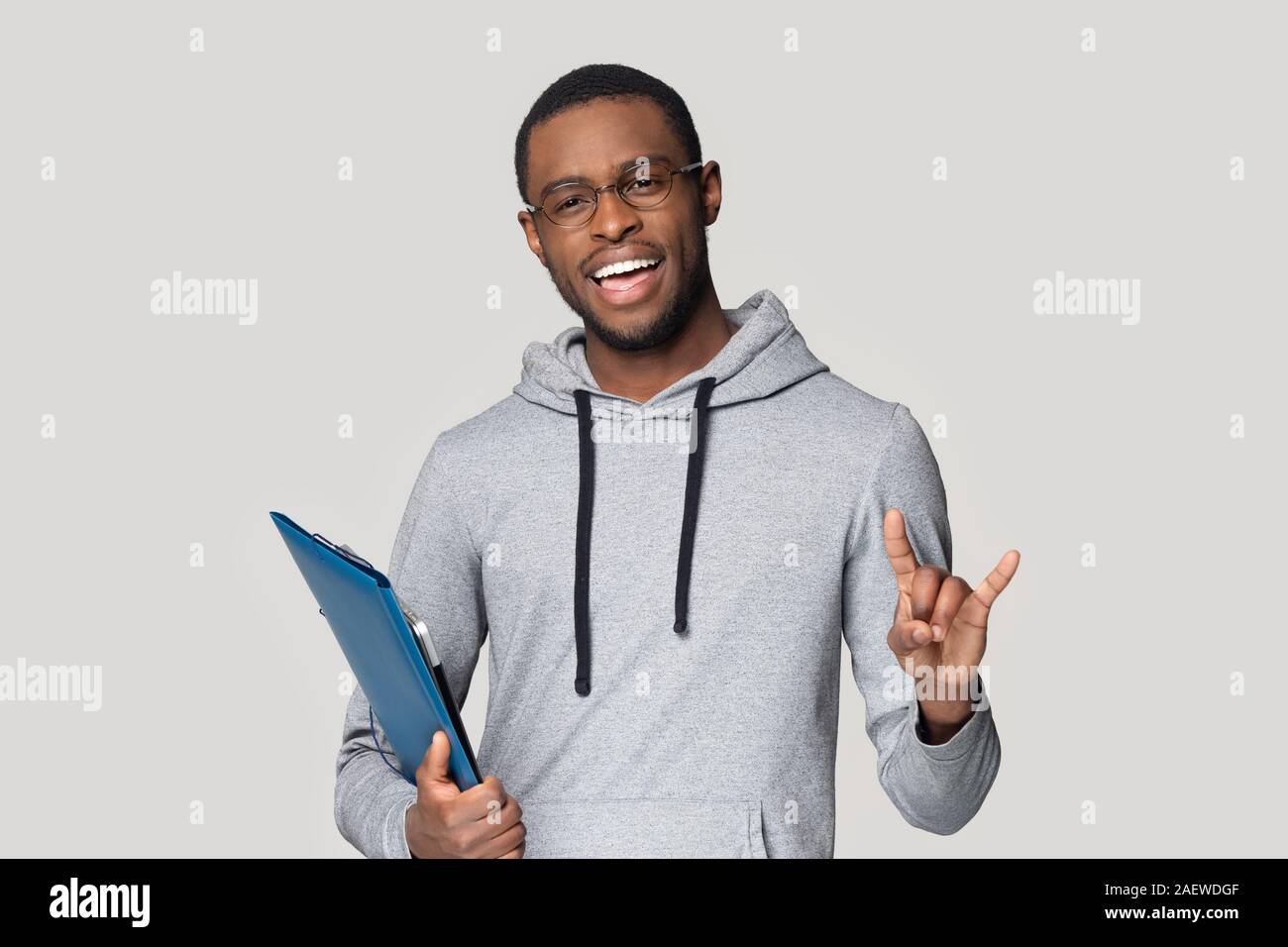 Young black professional standing with documents in folder. Stock Photo