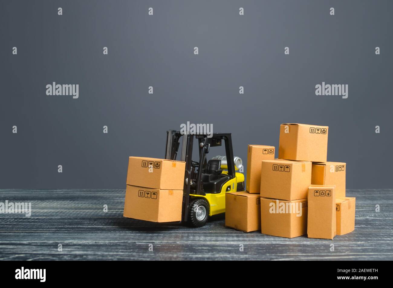 Yellow Forklift truck and cardboard boxes. Production, transport, cargo storage. Freight shipping. retail. Transportation logistics infrastructure, im Stock Photo