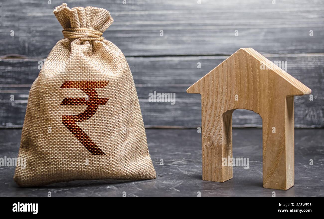 Indian rupee INR symbol money bag and house. Real estate purchase and investment. Affordable loan, mortgage. Taxes, rental income. rent or buy. Home b Stock Photo