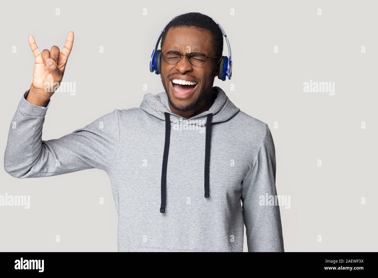 Crazy happy young african american male melomaniac keen on music. Stock Photo