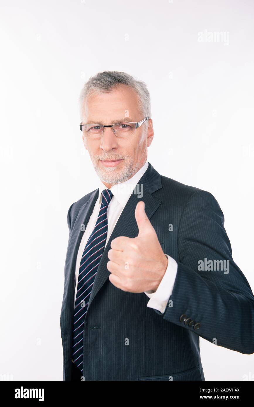 confident intelligent businessman showing thumb up Stock Photo - Alamy