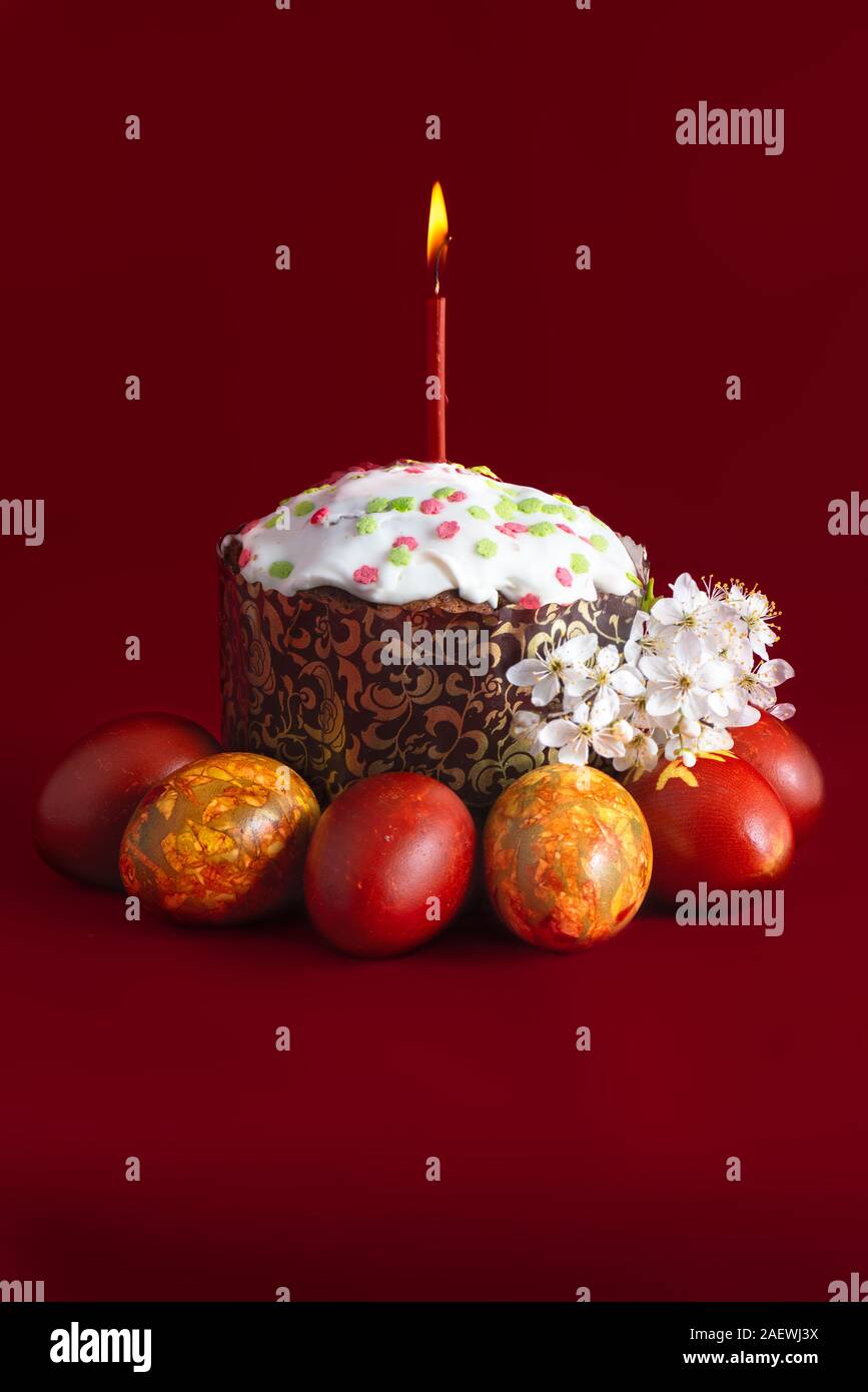 Traditional easter cake kulich and eggs burning candle Stock Photo