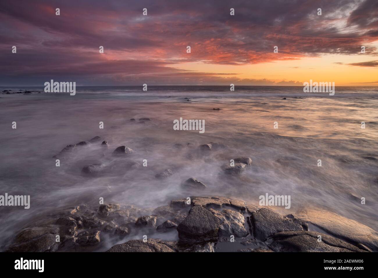 Beautiful sunset at the rocky beach of the Old Kona Airport State Recreation Area on Big Island Hawaii, USA. Stock Photo