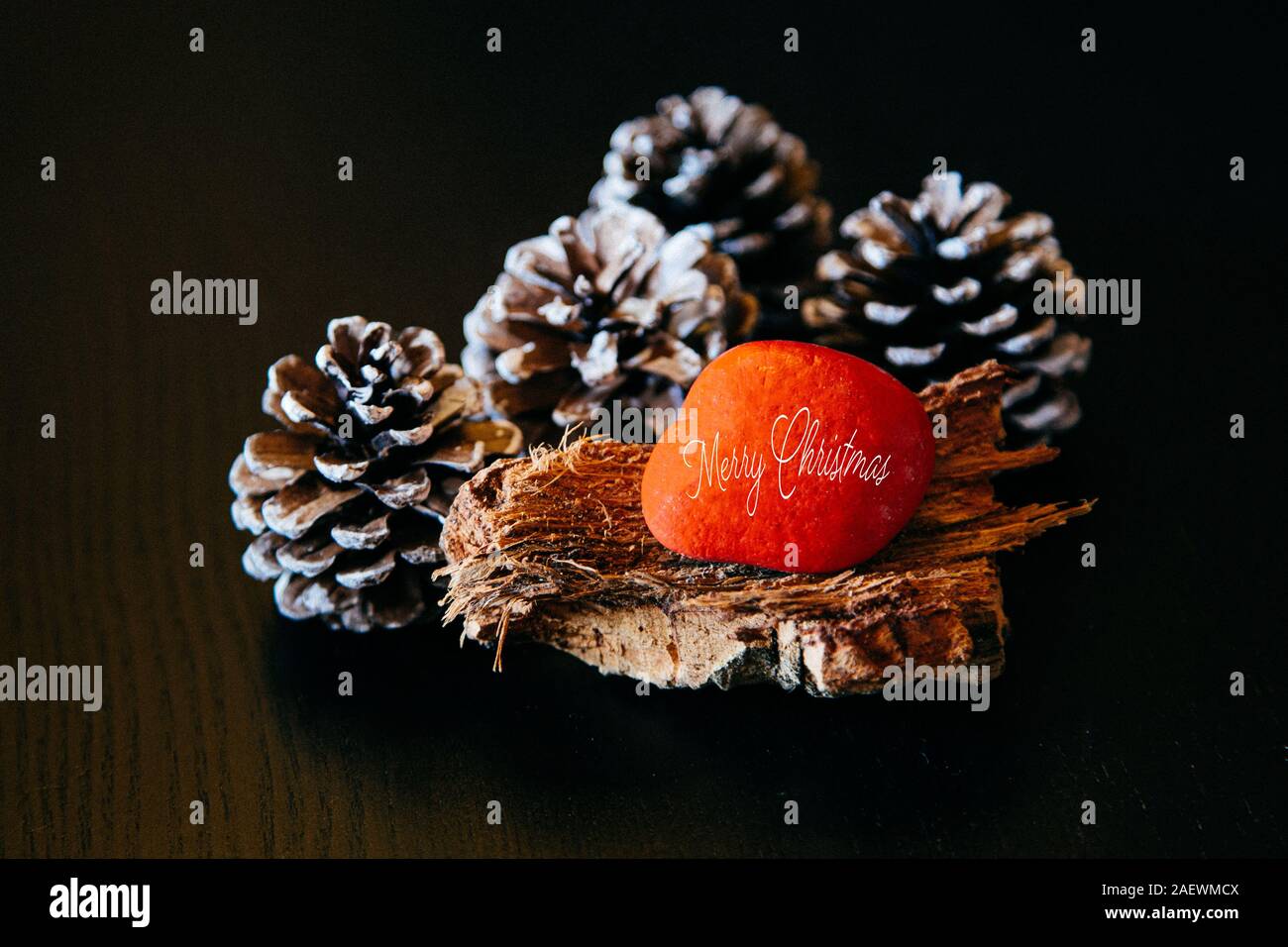 Christmas background italian Buon Natale, natural Xmas decoration, pine cones on rustic wood Stock Photo