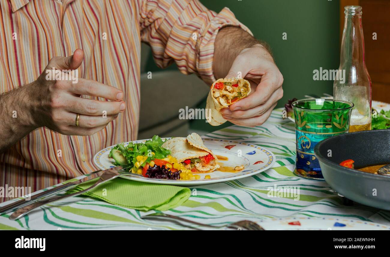Man hands eating mexican food Stock Photo