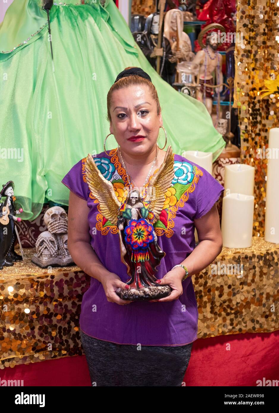 Posed photo of a leader of a Santa Muerte congregation at her home temple in Jackson Heights, Queens, New York City. Stock Photo