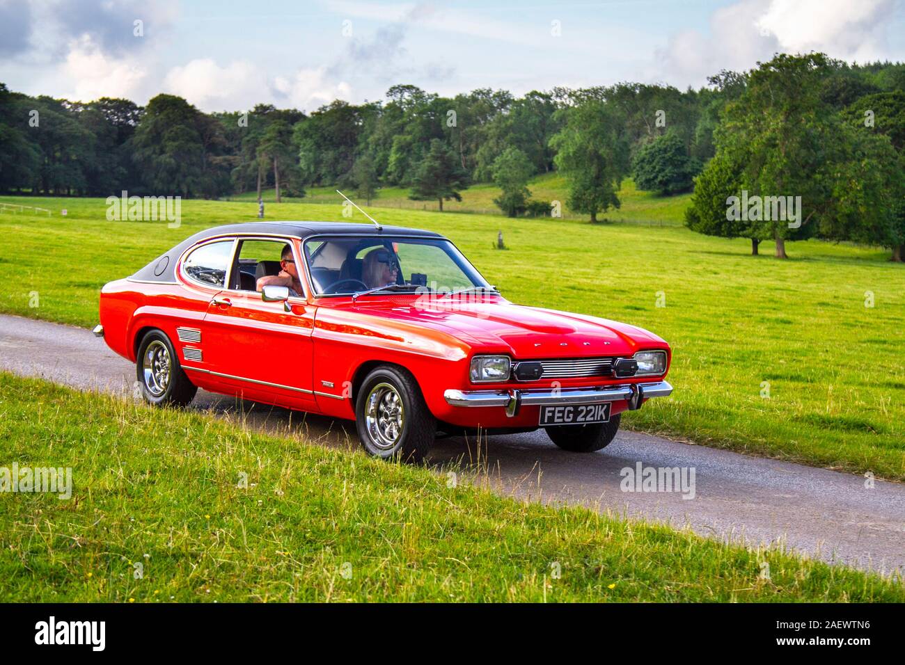 1972 70s seventies red Ford Capri 3000E; Classic cars, historics, cherished, old timers, collectable restored vintage veteran, vehicles of yesteryear arriving for the Mark Woodward historical motoring event at Leighton Hall, Carnforth, UK Stock Photo