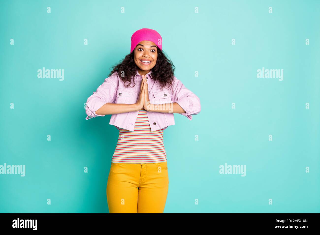 Photo of casual pretty cute nice charming excited overjoyed girl begging to use sales and buy new things in yellow pants striped t-shirt pink jacket Stock Photo