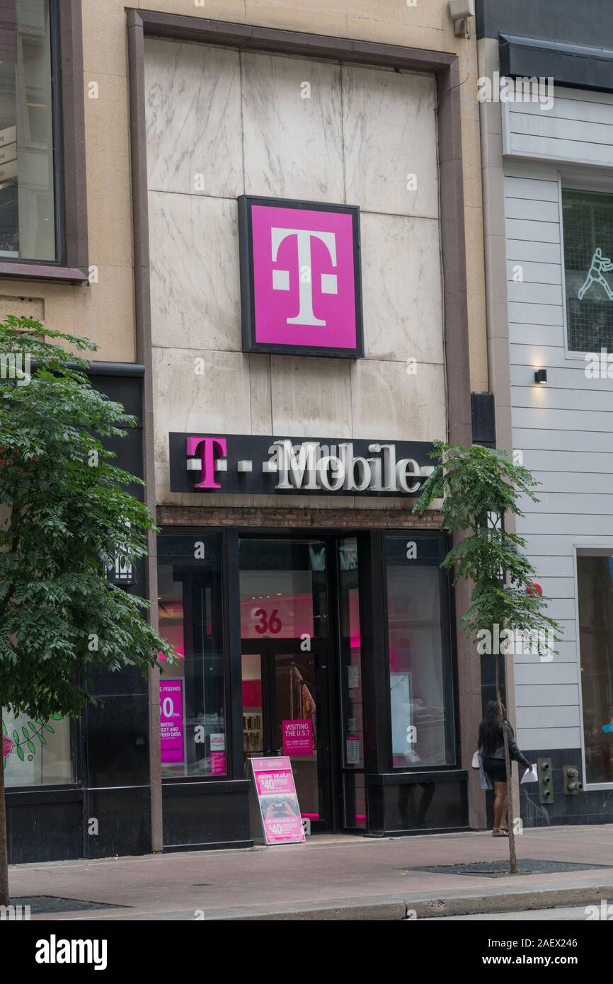 Chicago, USA - Circa 2019: T-Mobile retail store location exterior storefront facade photo. Wireliess cell phone service provider. Stock Photo