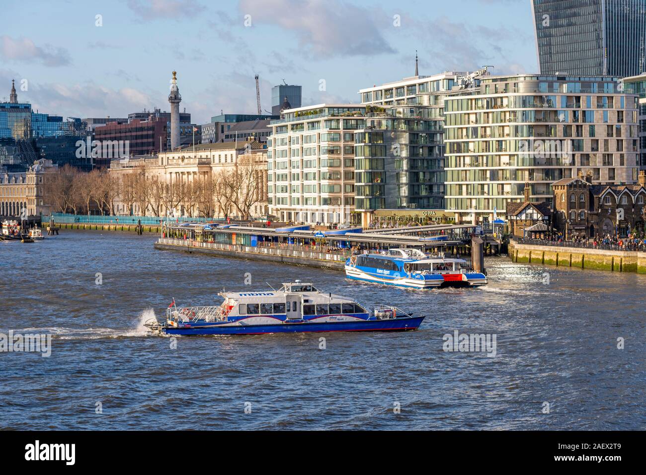 River traffic on River Thames, London, UK. MBNA Thames Clippers river buses, Storm Clipper and Jupiter Clipper approach Tower Millennium Pier Stock Photo