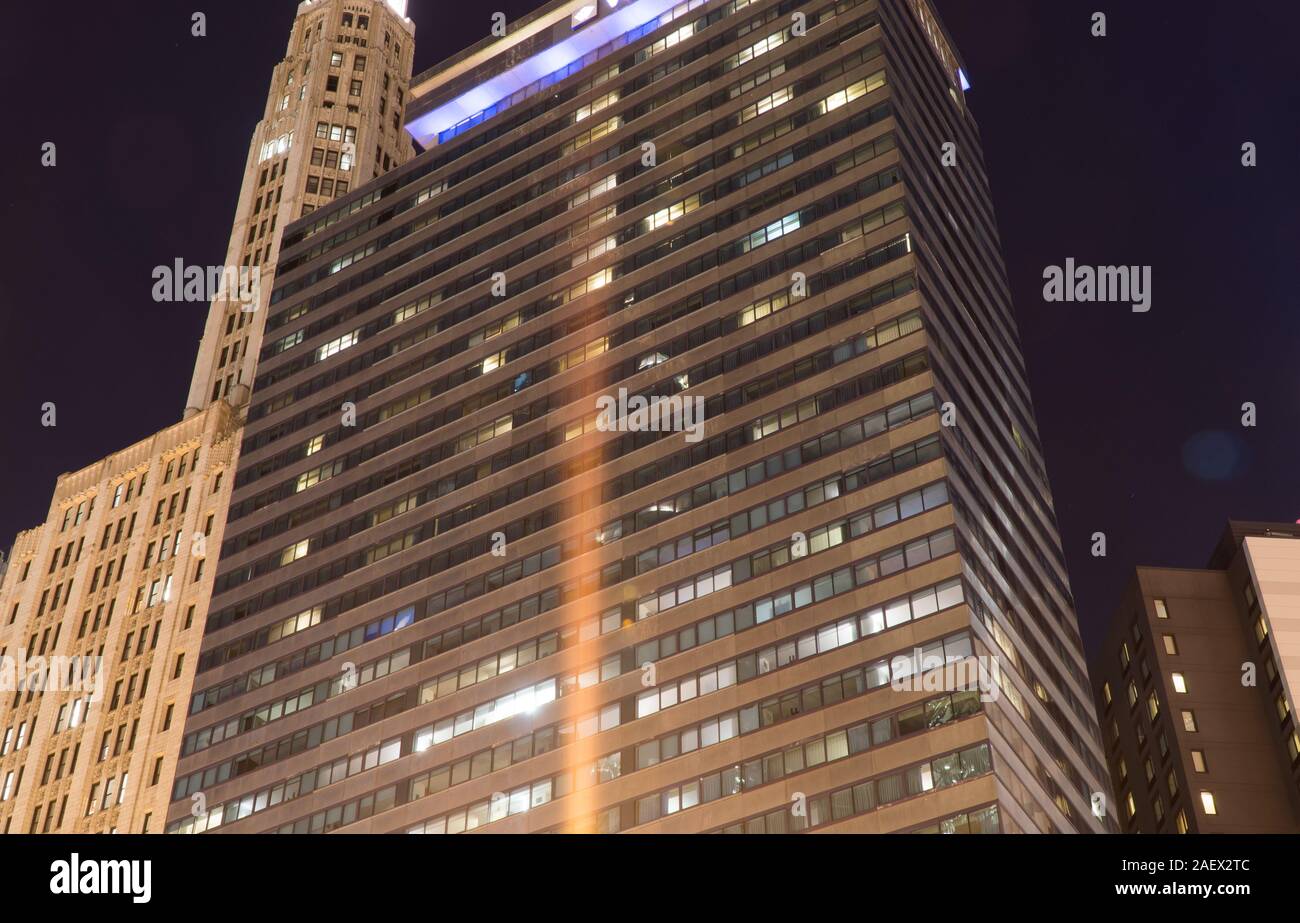 Chicago, IL - Circa 2019: Night time exterior establishing shot photo of a big city downtown apartment or office building illuminated to light up skyl Stock Photo