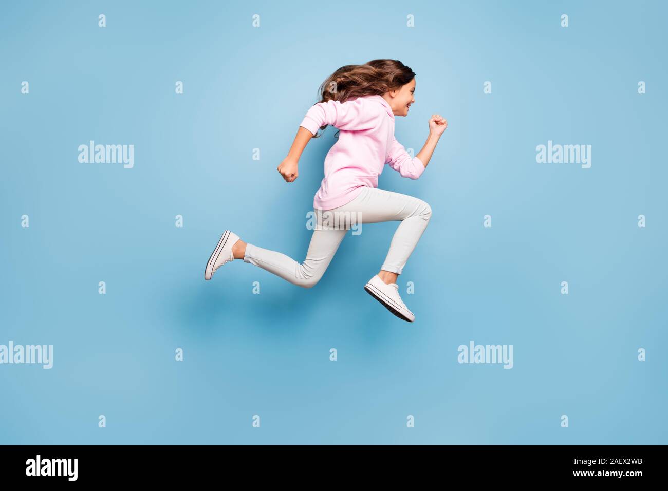 Full length body size photo of cheerful side profile positive crazy excited casual preteen wearing pink pants trousers footwear hurrying for discount Stock Photo