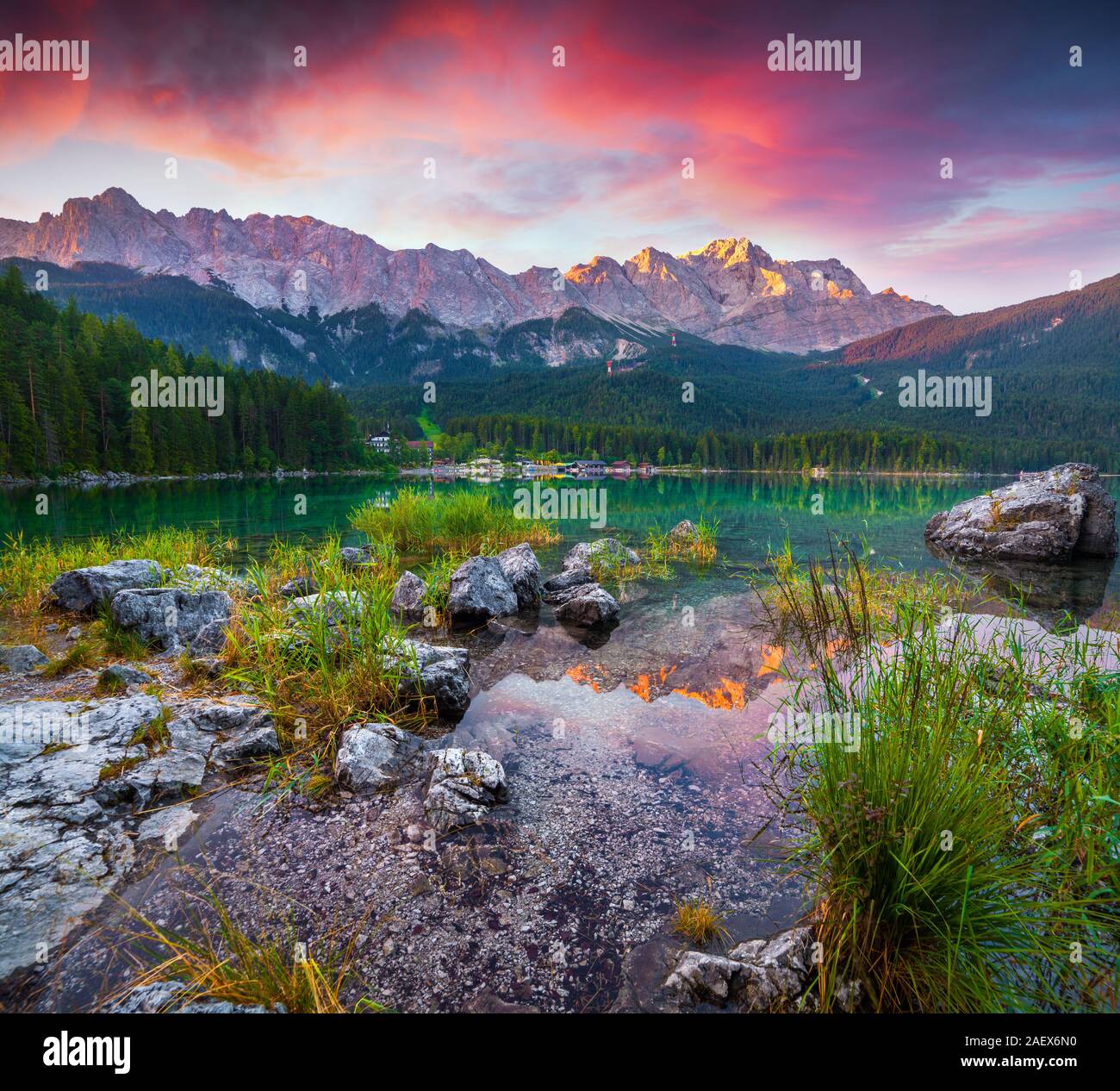 Colorful summer scene on the Eibsee lake in German Alps. Germany's highest mountain Zugspitze 2 962 m, and it's mountain ridge in the first rays of su Stock Photo
