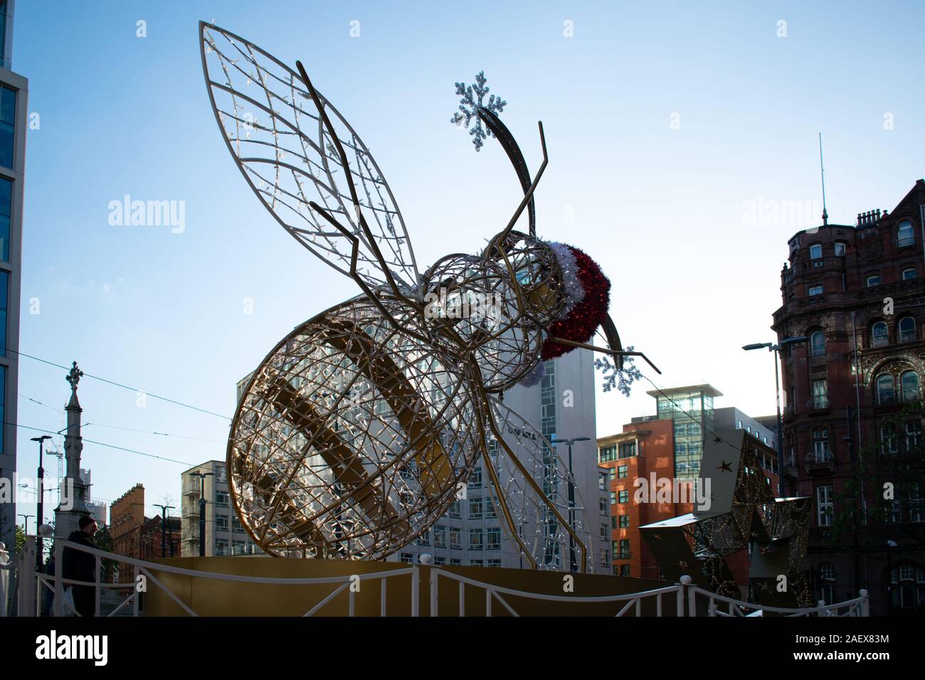 Manchester Bee Christmas style with Santa hat and evening sky in background.  A symbol of enterprise in the city in St Peter's Square Stock Photo