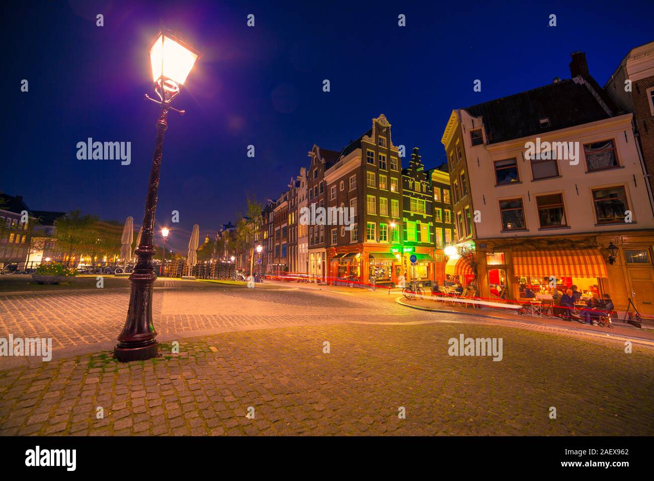 Night view streets of Amsterdam city. Dutch style buildings landscape in spring. Netherlands, Europe. Stock Photo