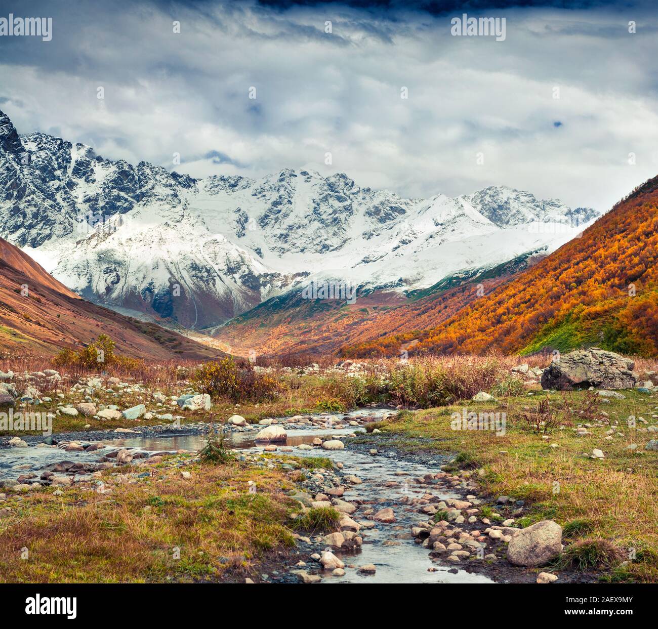 Southern foothills of mountain Shkhara. View from Ushguli village. Colorful autumn morning in Caucasus mountains, Upper Svaneti, Georgia, Europe. Arti Stock Photo