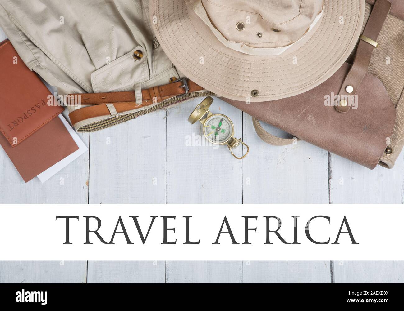 Prepare for journey in africa style - accessories and travel items, packing clothes in backpack: backpack, passport, tickets, hat, shorts, compass on Stock Photo
