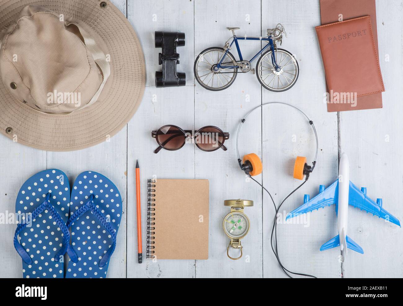 Prepare for journey - accessories and travel items, packing clothes: hat, passport, tickets, model of airplane and bicycle, flip flops, sunglasses, co Stock Photo