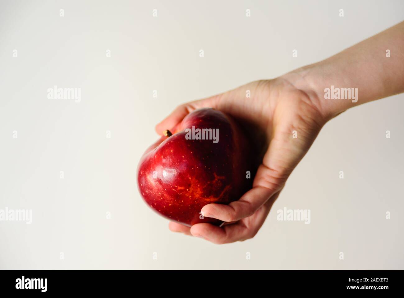 Big red apple in woman hand. Dieting and weight loss concept Stock Photo