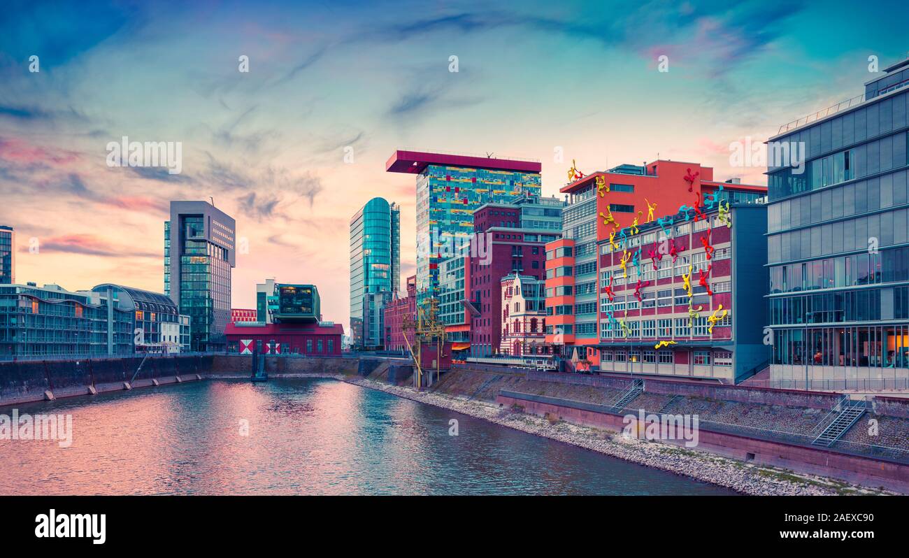 Colorful view of Rhine river at evening in Dusseldorf. Medienhafen in the soft sunset light, Nordrhein-Westfalen, Germany, Europe. Instagram toning. Stock Photo