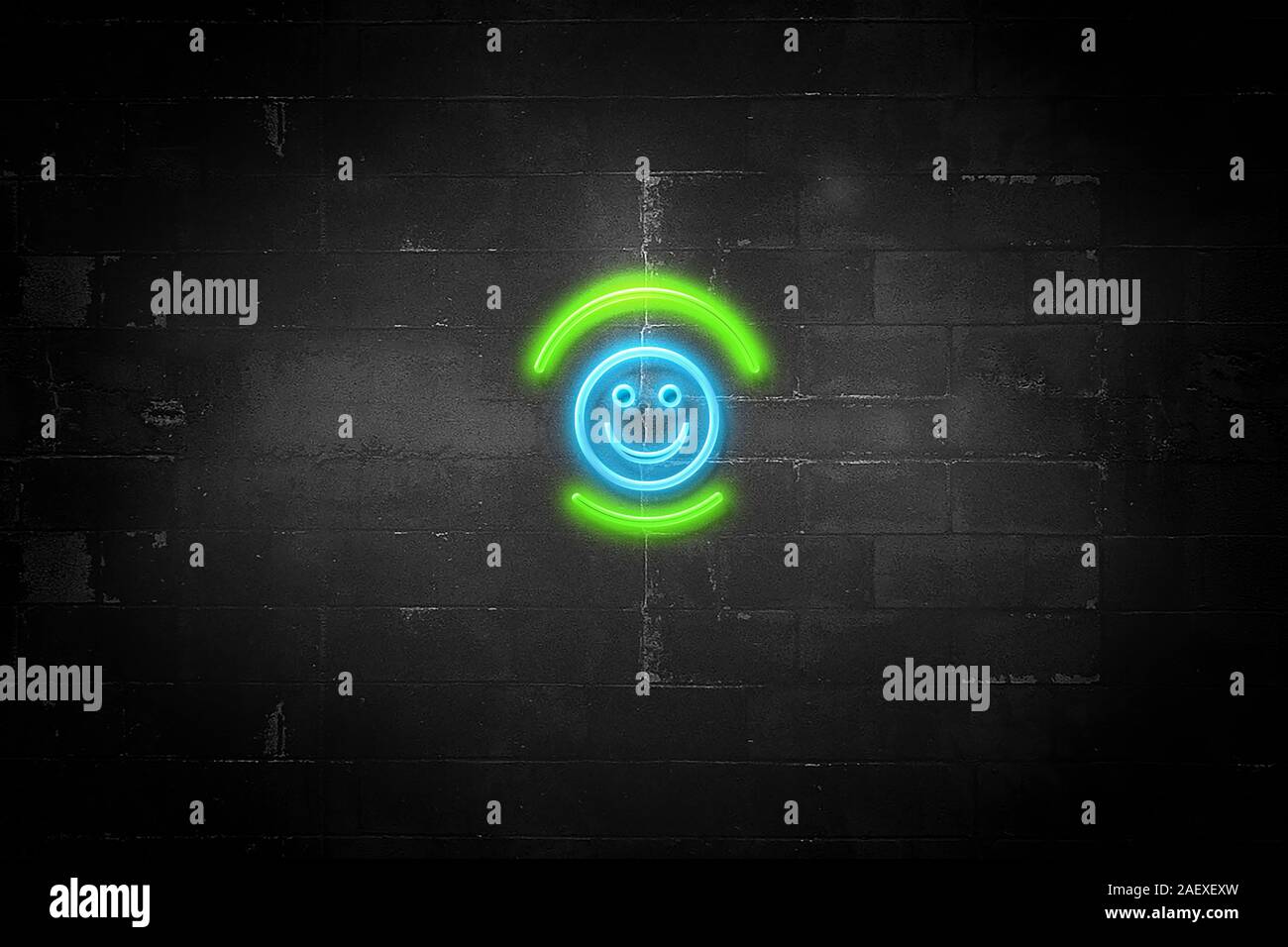 Happy emoji symbol on Neon sign with concrete wall background, the sign