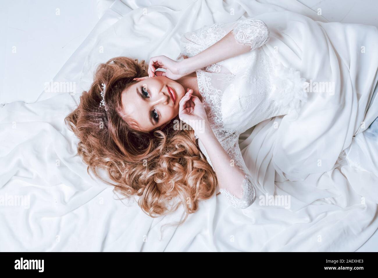 the bride in her wedding dress lay Stock Photo Alamy