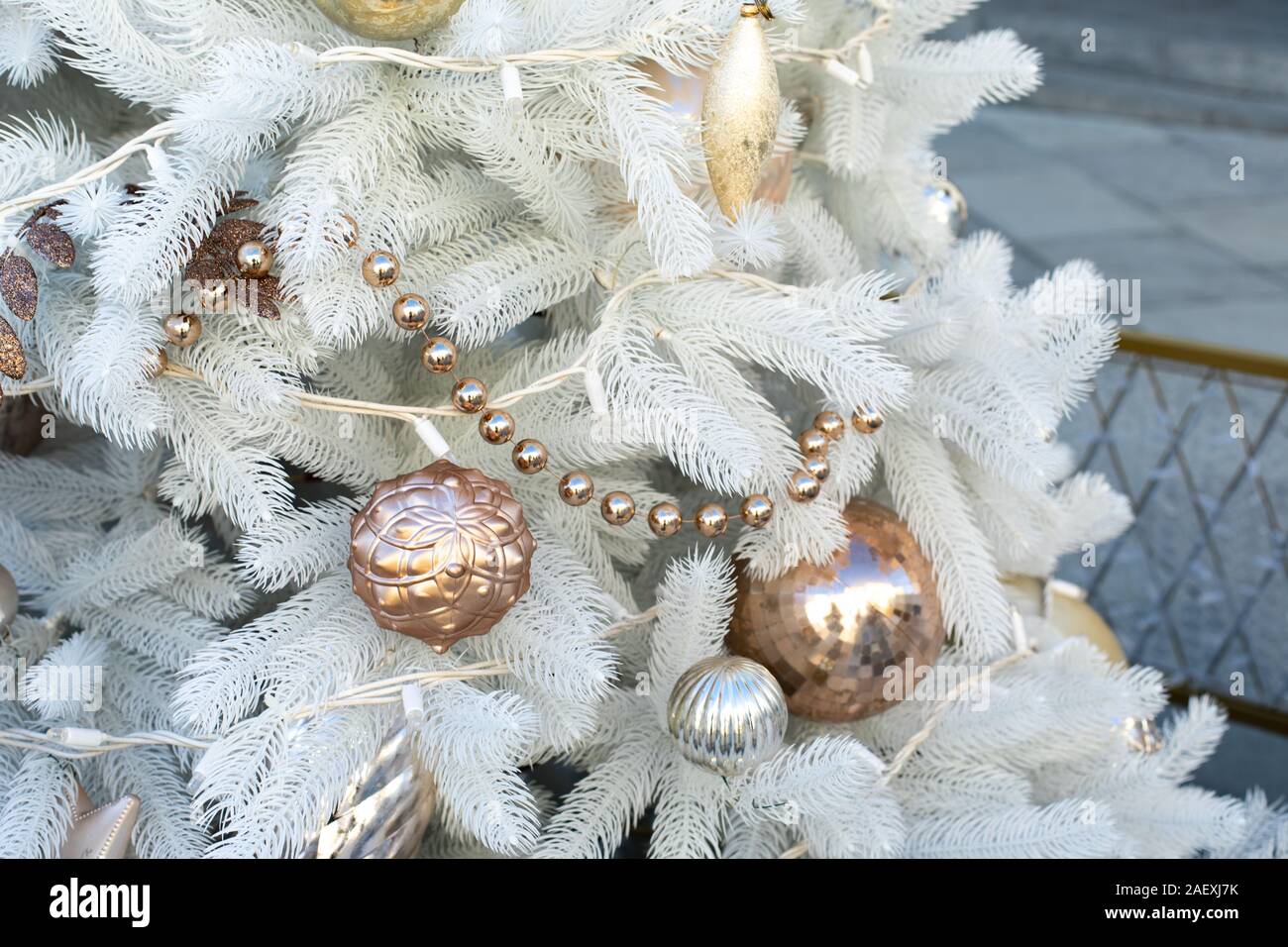 Golden Toy Decorations On A White Artificial Christmas Tree Shao
