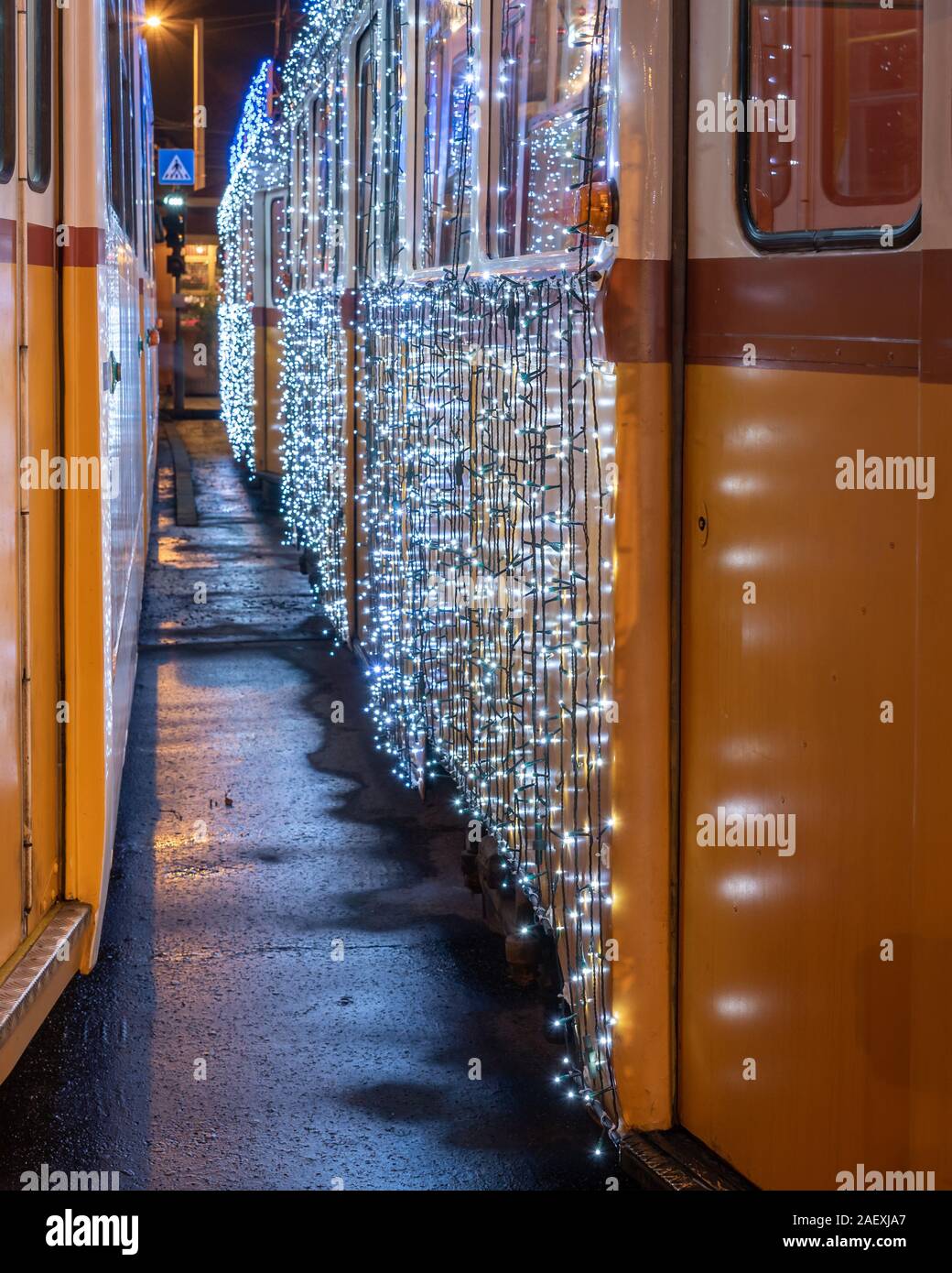 Festively decorated light tram (fenyvillamos) by night. Christmas season in Budapest . Vintage tram from Budapest city decorated with Christmas lights Stock Photo