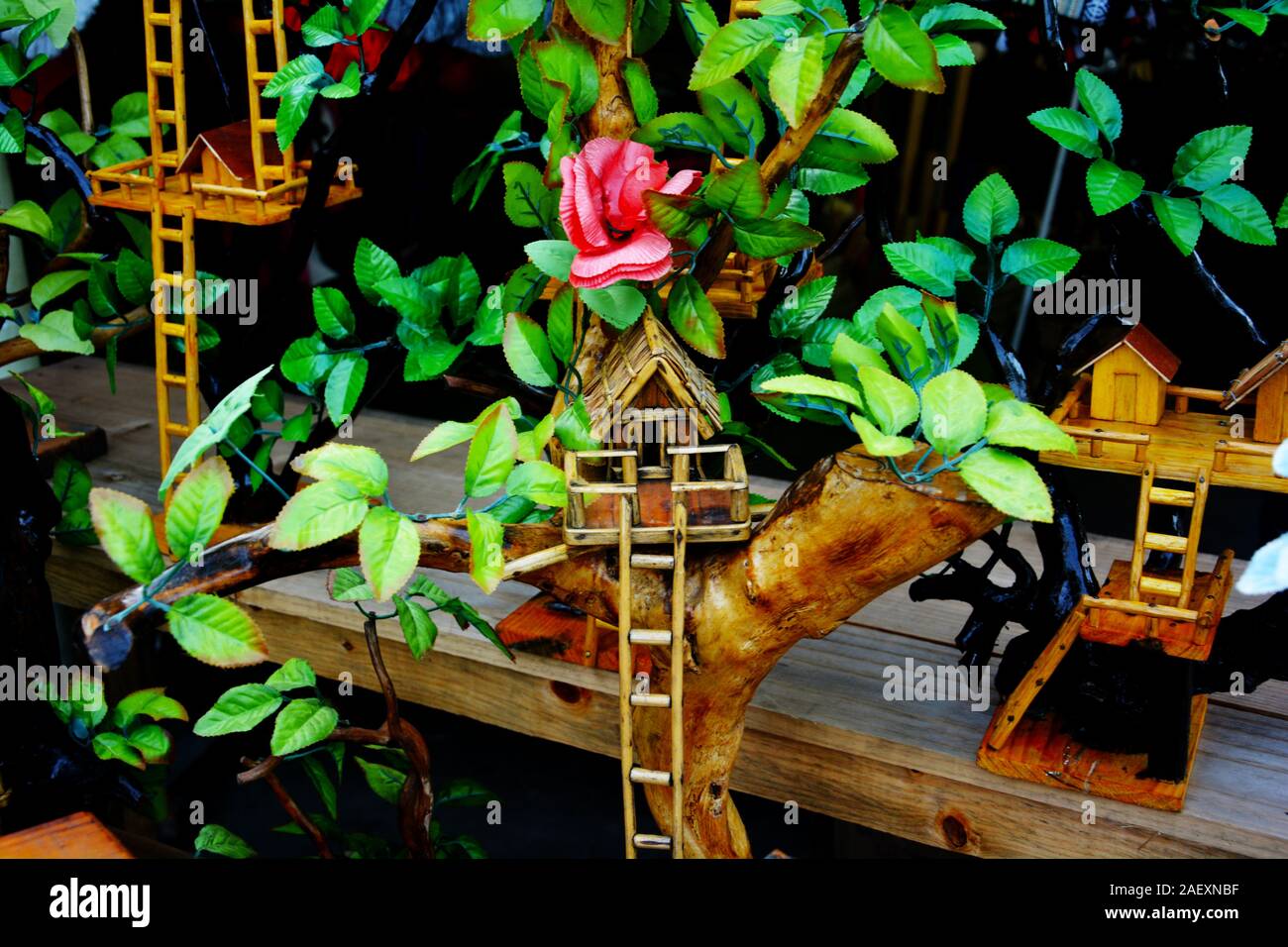 Close up of very beautiful small toys tree houses made of wood, bamboos with green leaves, displayed for sale in Elephant Hills of Shillong, Meghalaya Stock Photo