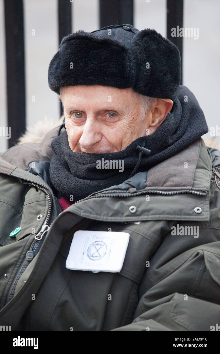 London, UK, 11 December 2019: Extinction Rebellion activist Professor Peter Cole on the 24th day of his hunger strike sits outside Conservative Party headquarters in London, waiting for someone from the Conservative Party to come out and discuss climate crisis issues with him. Anna Watson/Alamy Live News Stock Photo