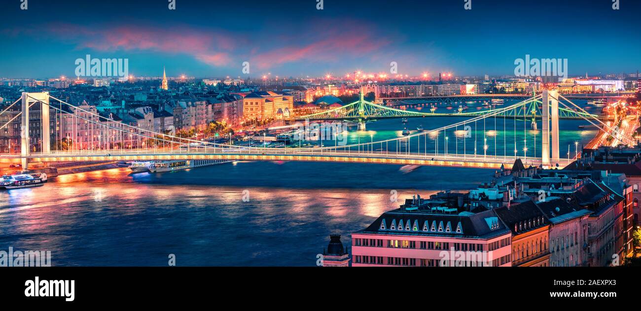 Panoramic cityscape of Pest city with Elisabeth Bridge on the Danube river. Colorful spring sunset in Budapest, capital of Hungary, Europe. Artistic s Stock Photo