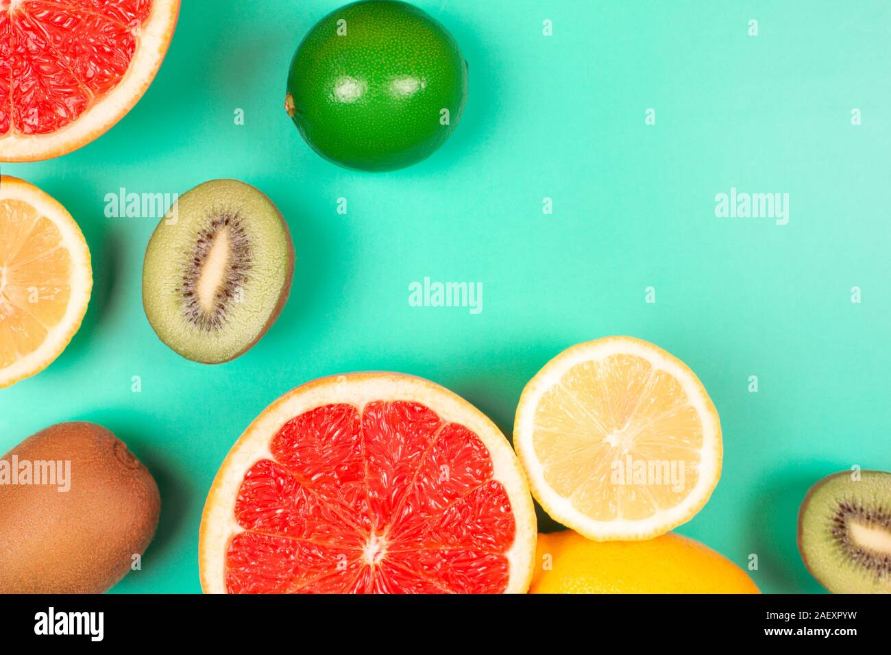 Fruits on trendy green background. Flat lay style. Stock Photo