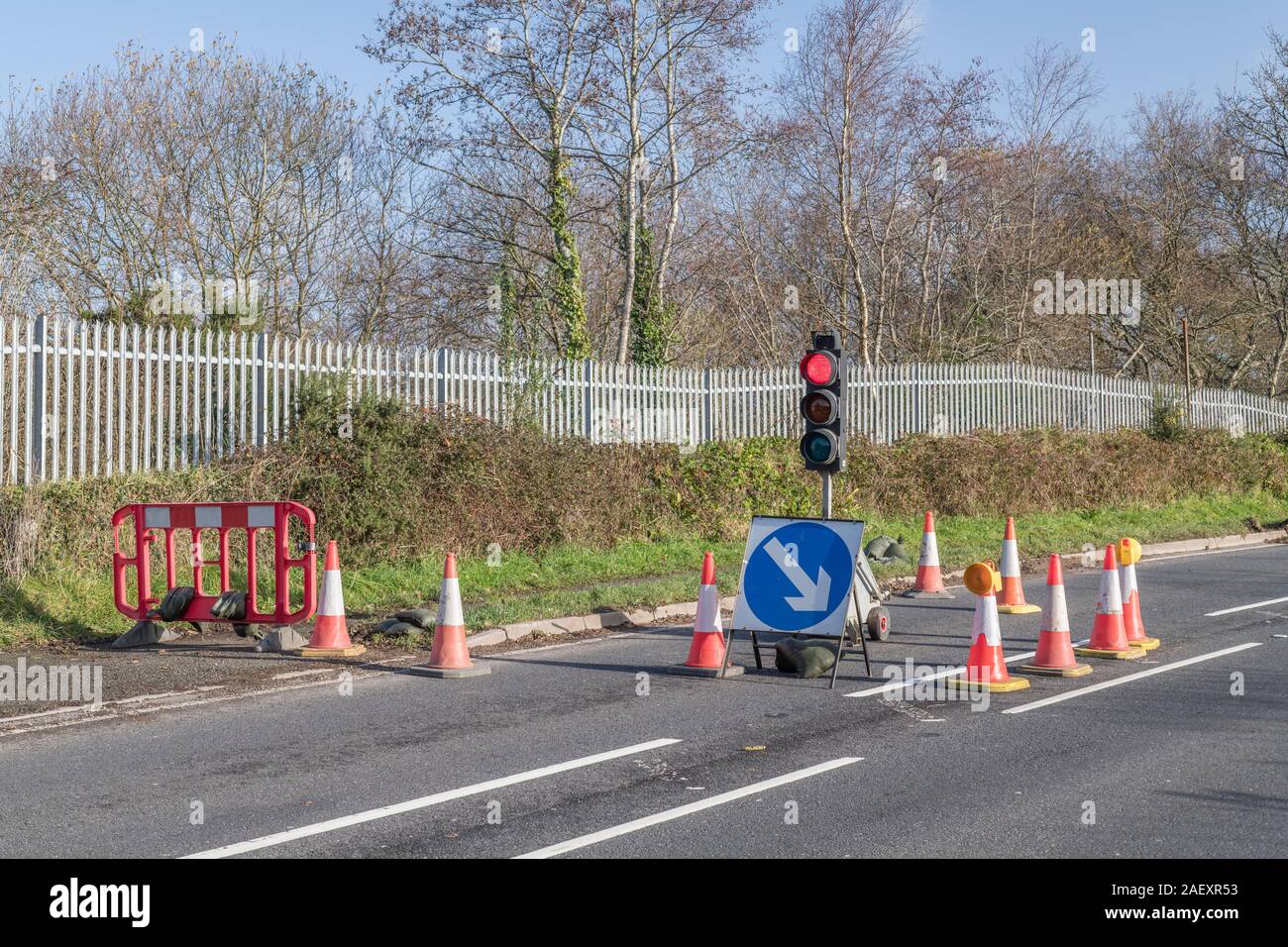 Temporary traffic lights at rural roadworks surrounded by orange