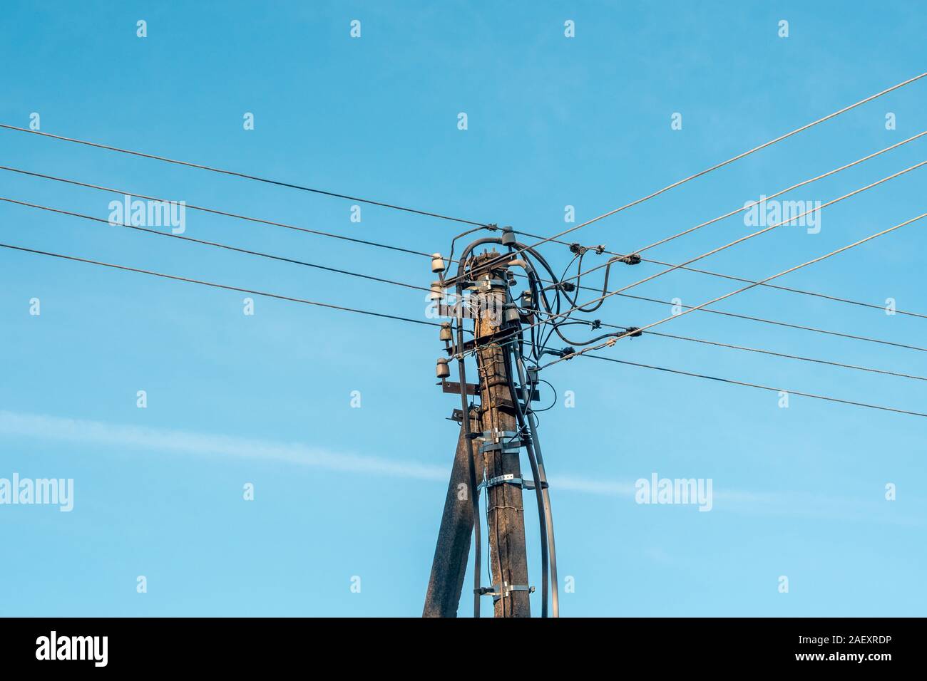 Electrical pole and cables on the clear sky background Stock Photo - Alamy