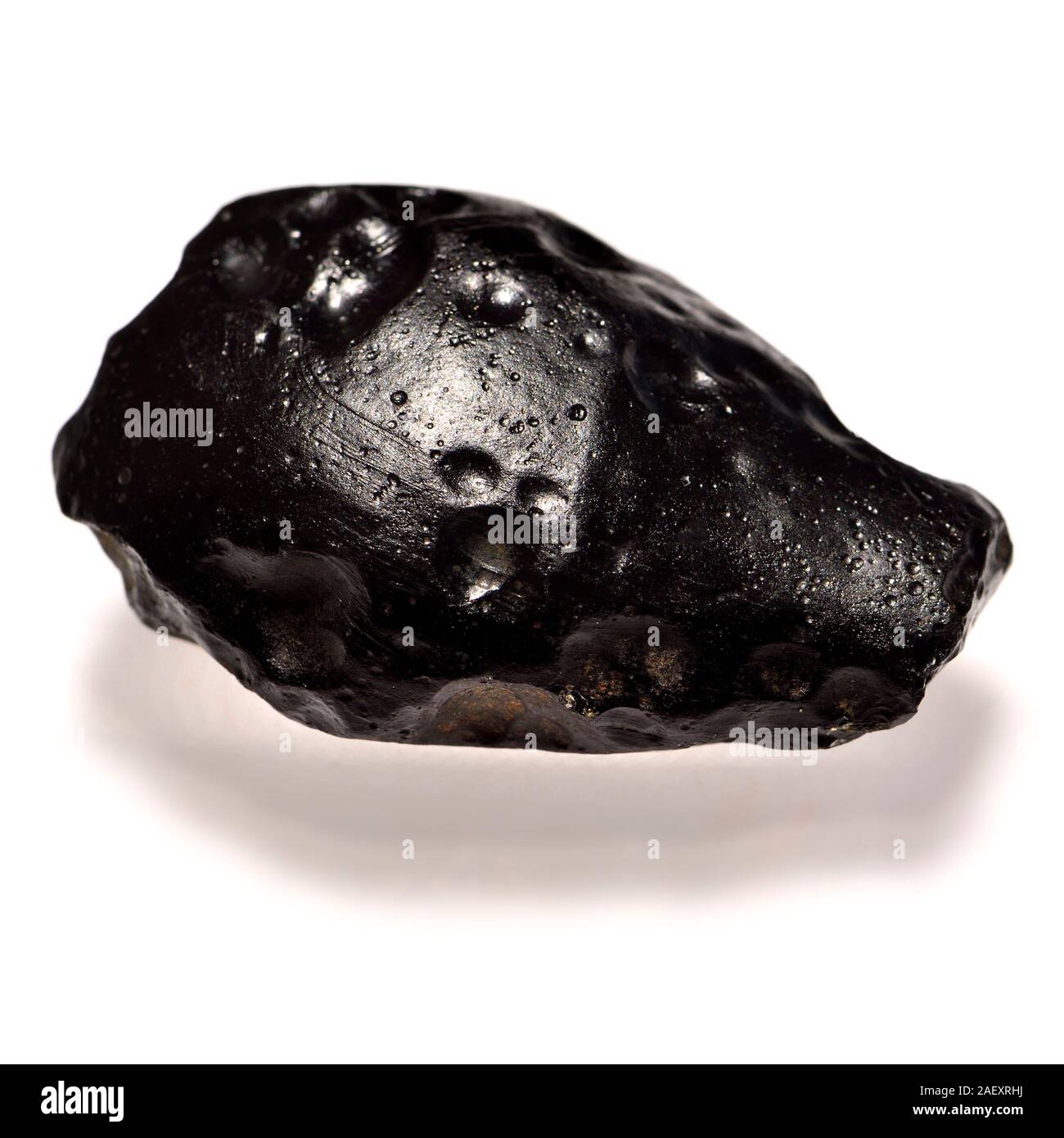 Indochinite /Tektite - metamorphic glass formed from terrestrial rock melting after meteorite impact and cooling quickly Stock Photo