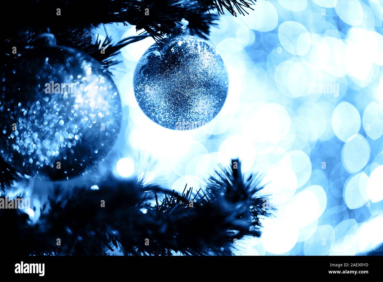 Fir branch with balls and festive lights on the Christmas background ...