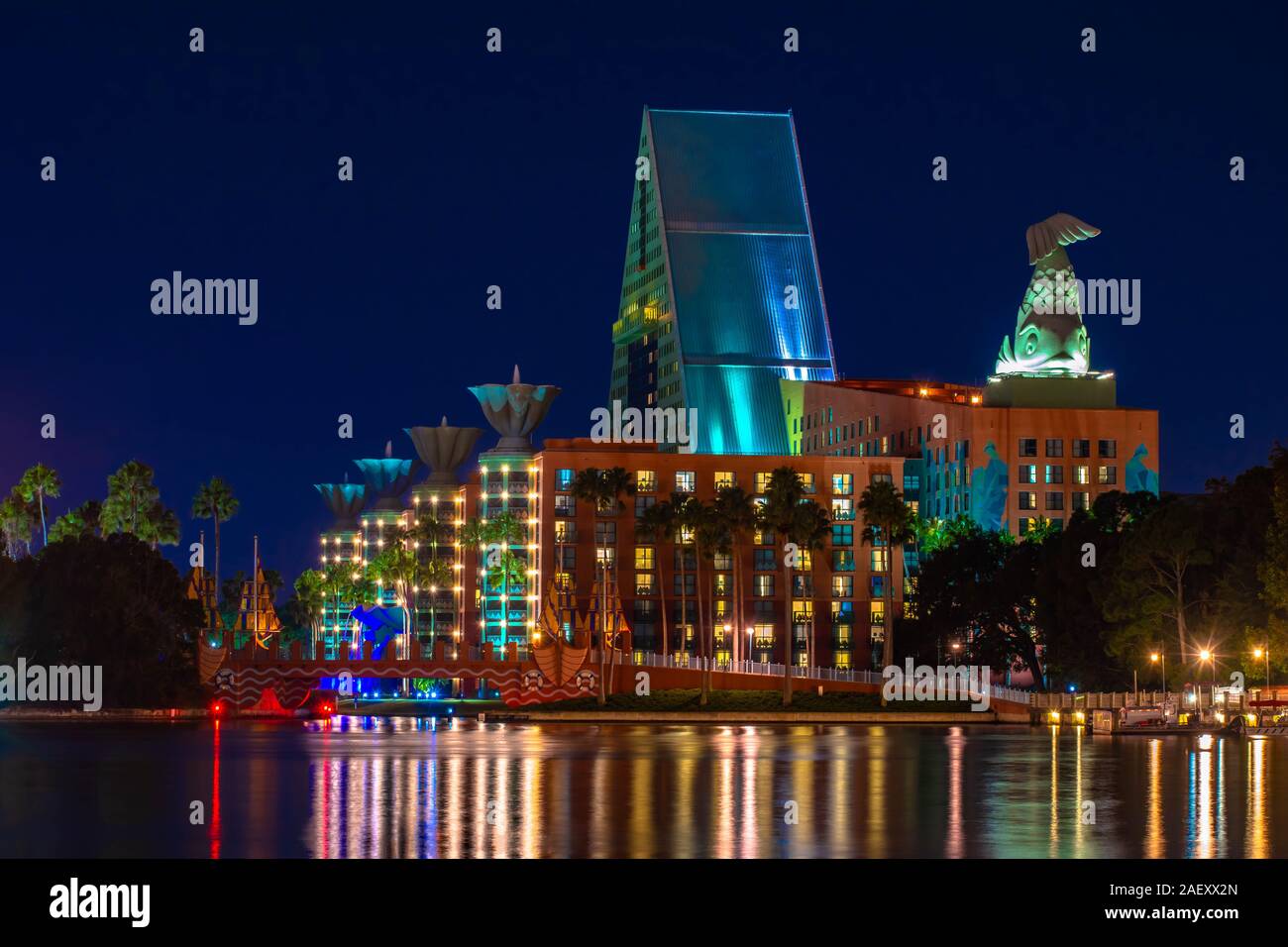 Orlando, Florida. December 06, 2019. Colorful and illuminated hotel with dolphin statue at Lake Buena Vista Stock Photo