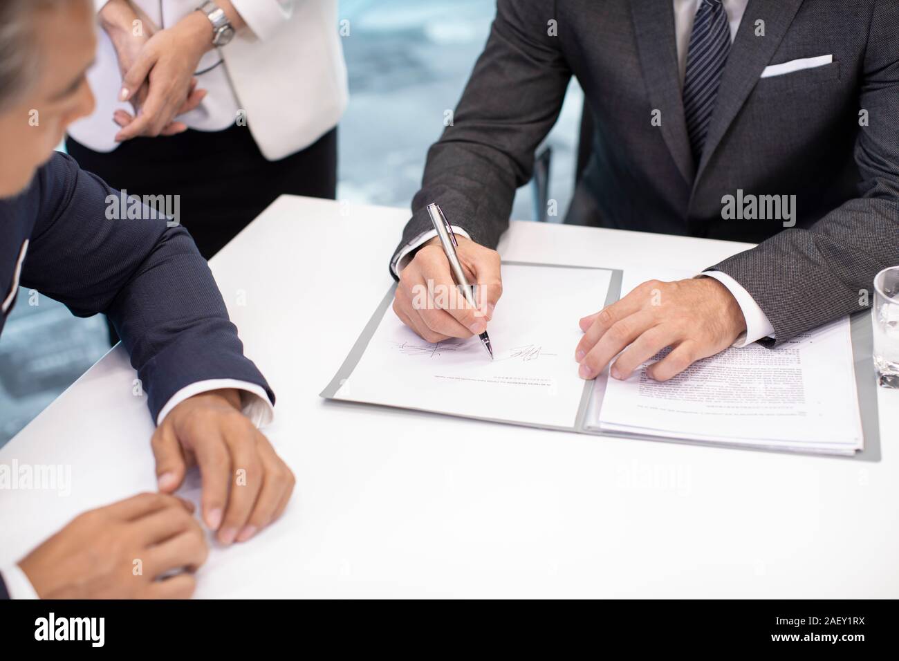 Business people signing contract in conference room Stock Photo