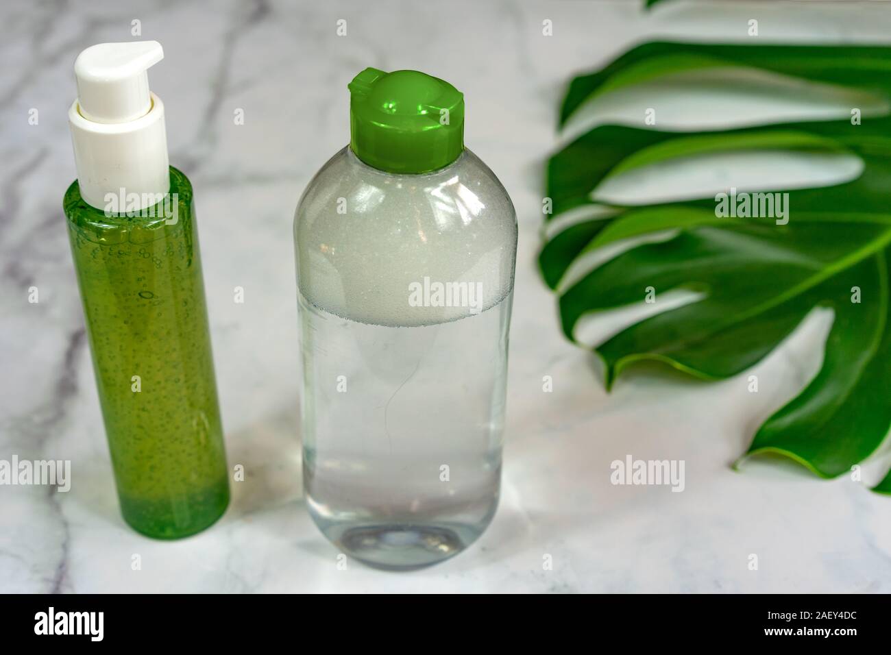 bio cosmetic products on marble background with leaves . Stock Photo