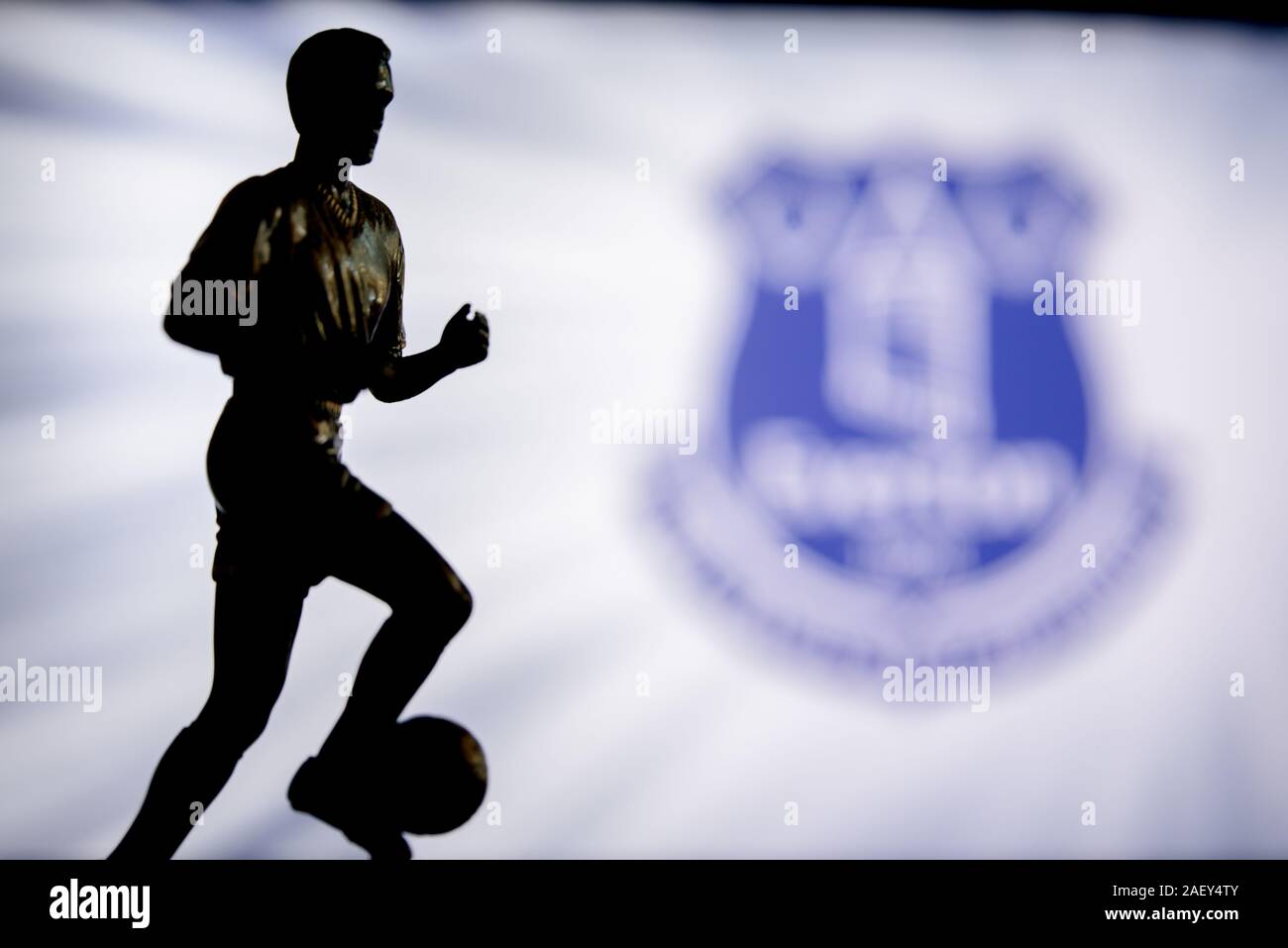 LONDON, ENGLAND, JULY. 1. 2019: Everton Football club logo, Premier League, England. Soccer player silhouette. Stock Photo