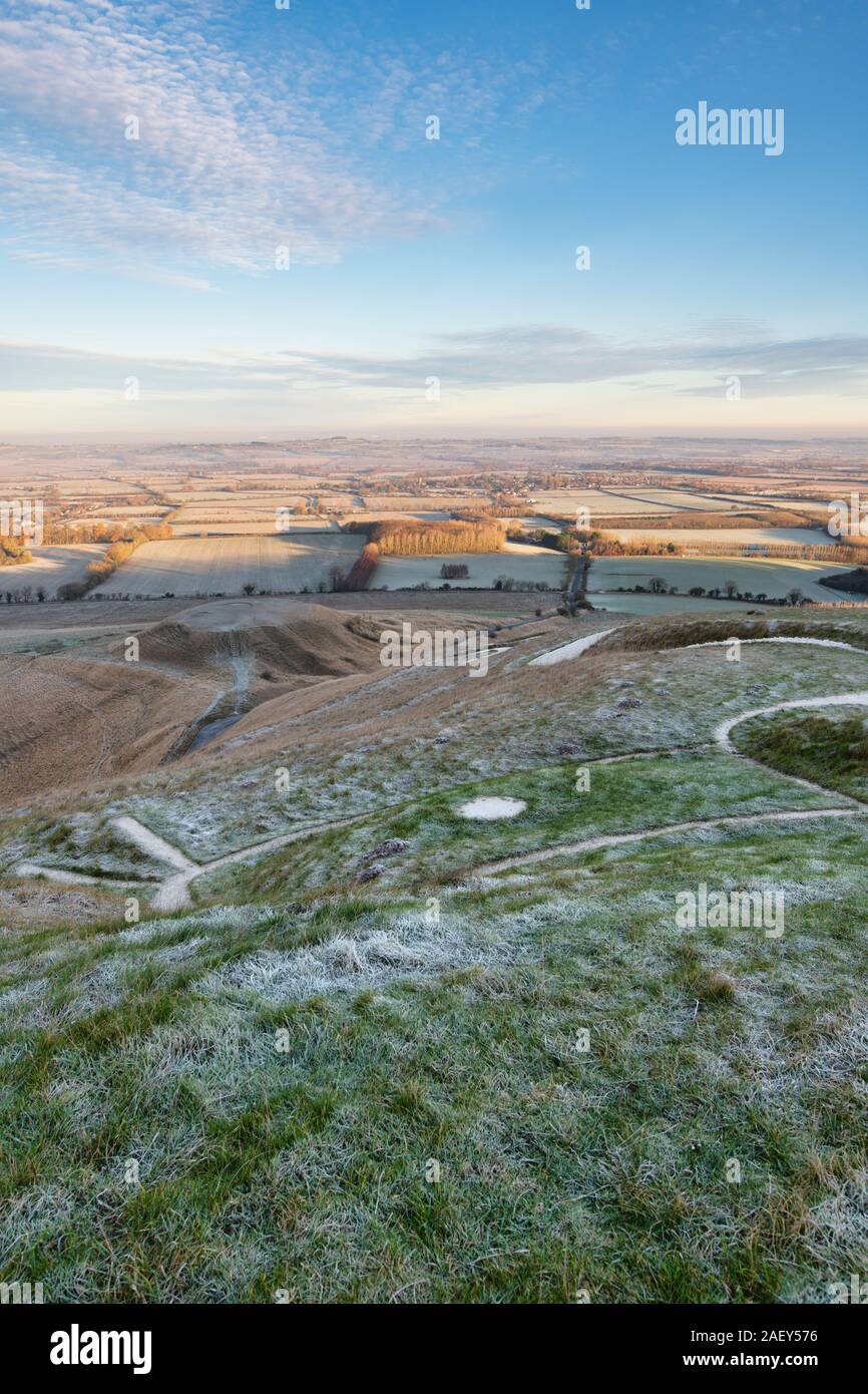 White horse hill and Dragon Hill in the early morning December frost at Uffington, viewed from