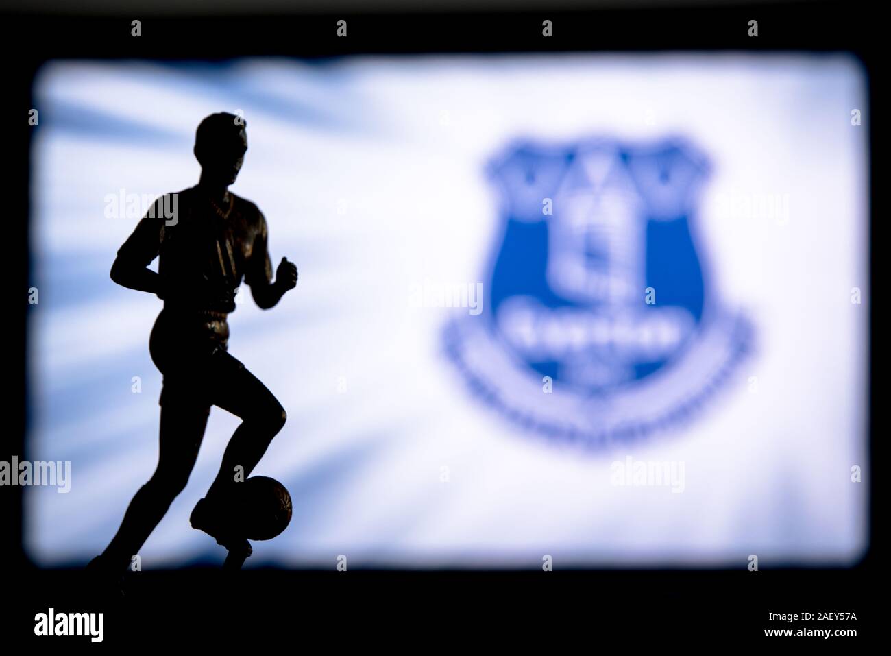 LONDON, ENGLAND, JULY. 1. 2019: Everton Football club logo, Premier League, England. Soccer player silhouette. Stock Photo