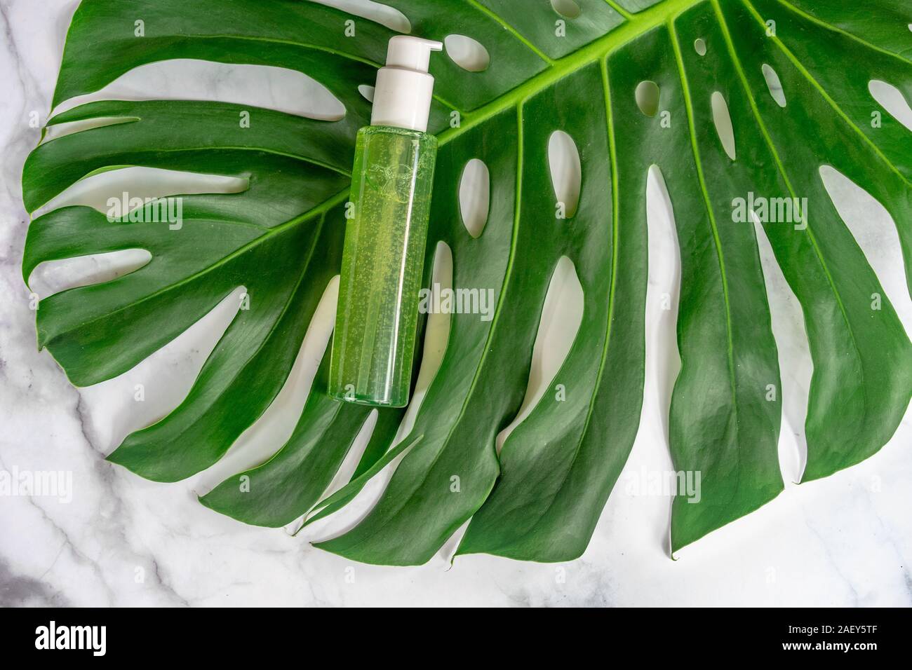 bio cosmetic product on leaf with marble background . Stock Photo