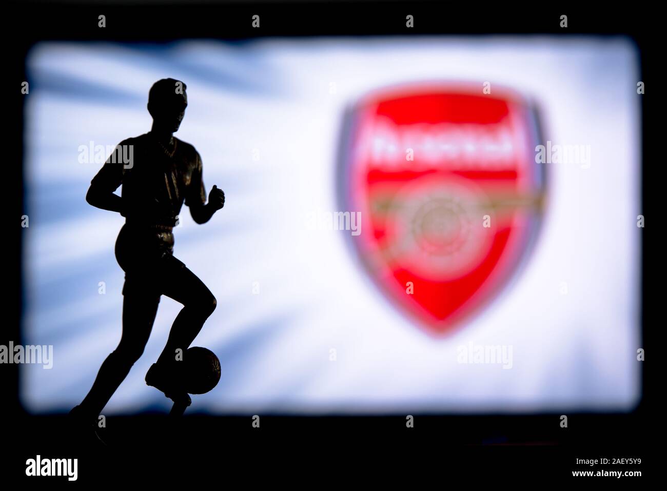 LONDON, ENGLAND, JULY. 1. 2019: Arsenal Football club logo, Premier League, England. Soccer player silhouette. Stock Photo