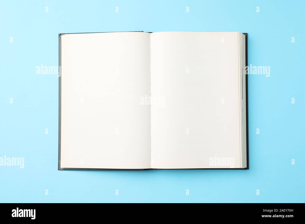 Opened empty book on blue background, top view Stock Photo