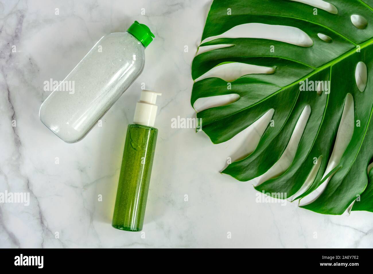 bio natural cosmetic products next to leaf with marble background . Stock Photo