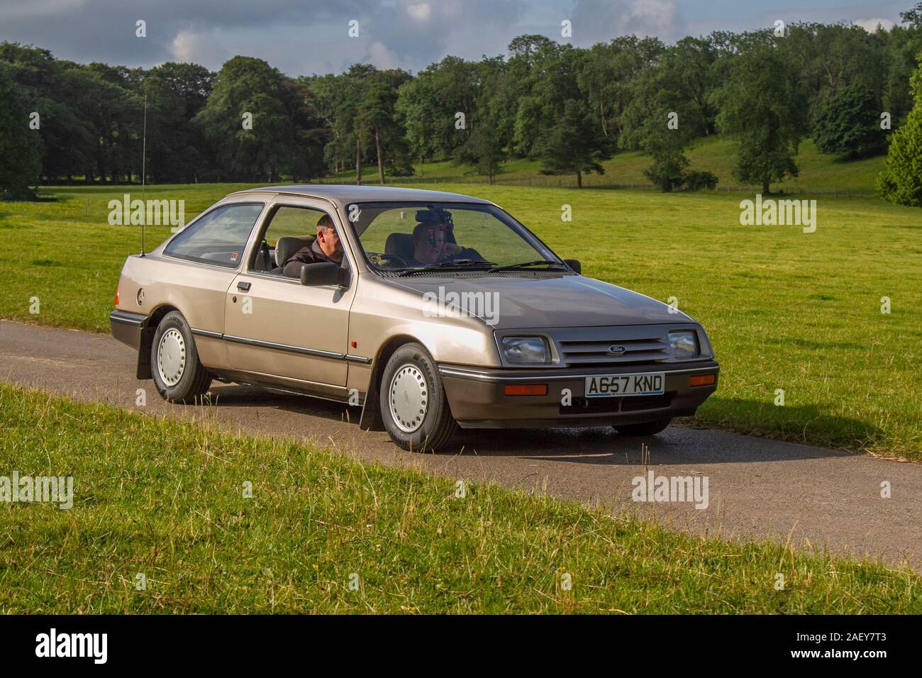 1983 80s gold Ford Sierra; Vintage classic cars, historics, cherished, old timers, collectable restored vintage veteran, 80s vehicles of yesteryear arriving for the Mark Woodward motoring collector event at Leighton Hall, Carnforth, UK Stock Photo