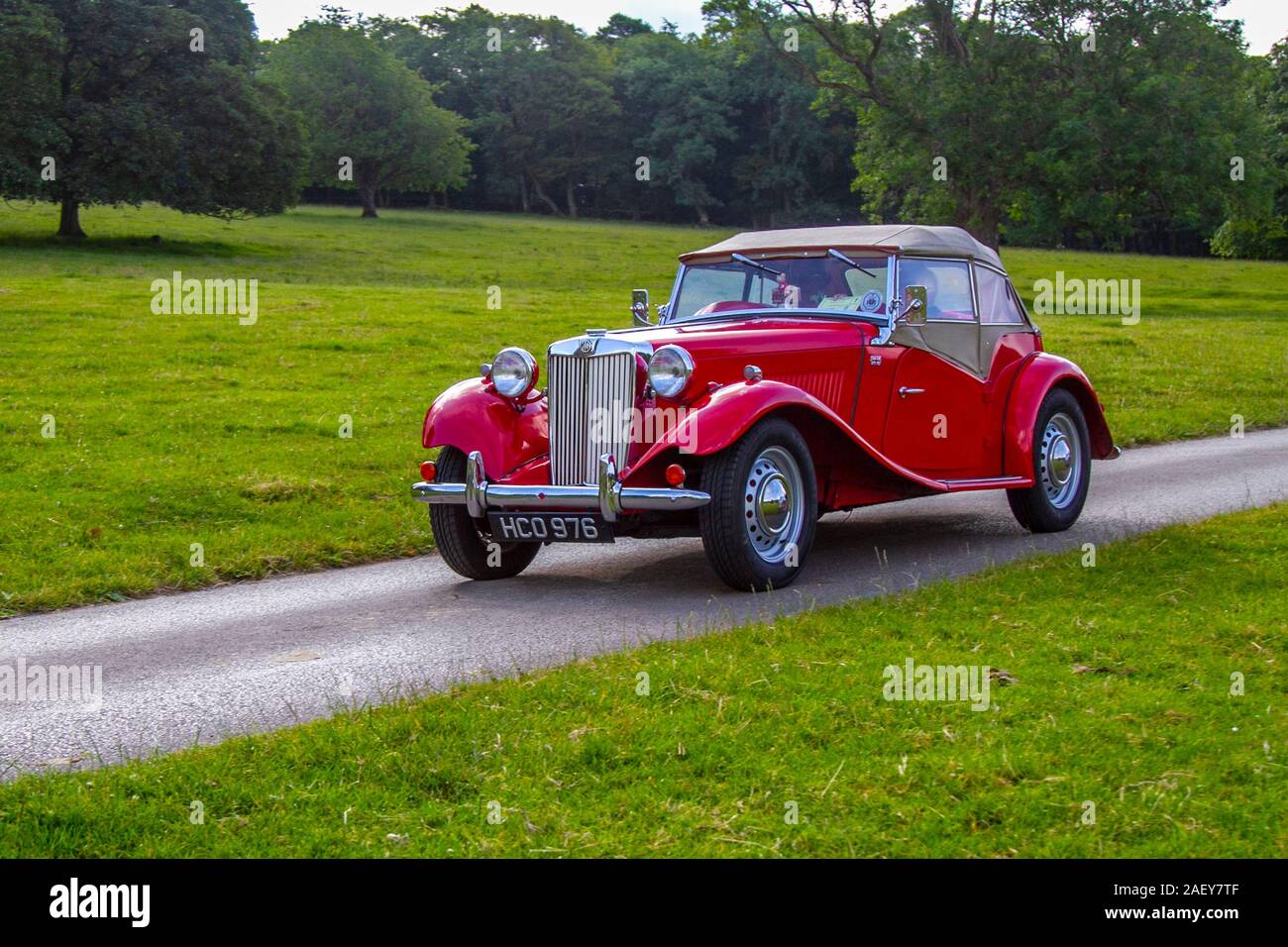 1953 50s red British MG Midget: Vintage classic cars, historics, cherished, old timers, collectable restored vintage veteran, vehicles of yesteryear arriving for the Mark Woodward motoring collector event at Leighton Hall, Carnforth, UK Stock Photo