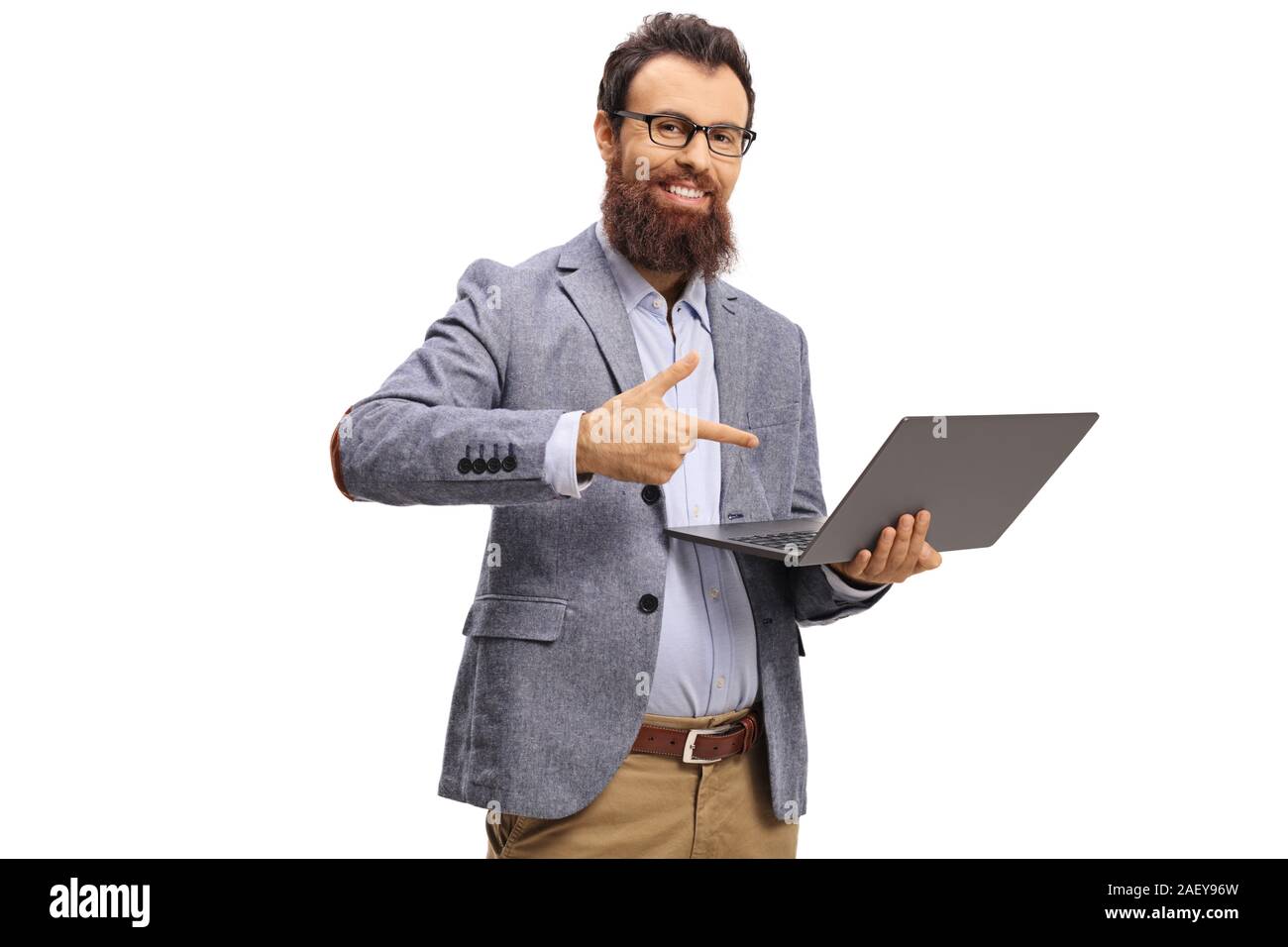 Bearded man holding a laptop and pointing at the computer isolated on ...